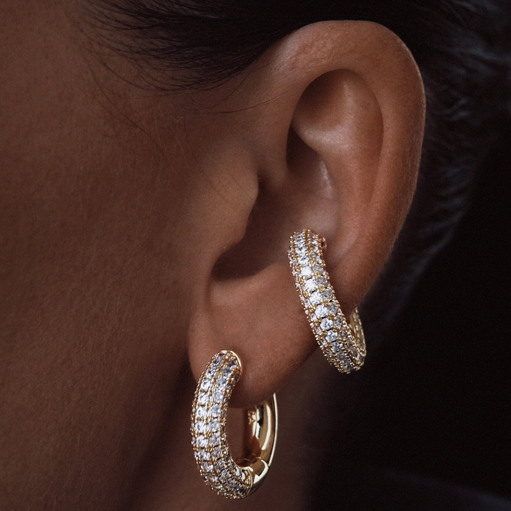 Chunky pavé zirconia hoop earring in 14k gold plated presented on an ear – Billion Avenue jewelry