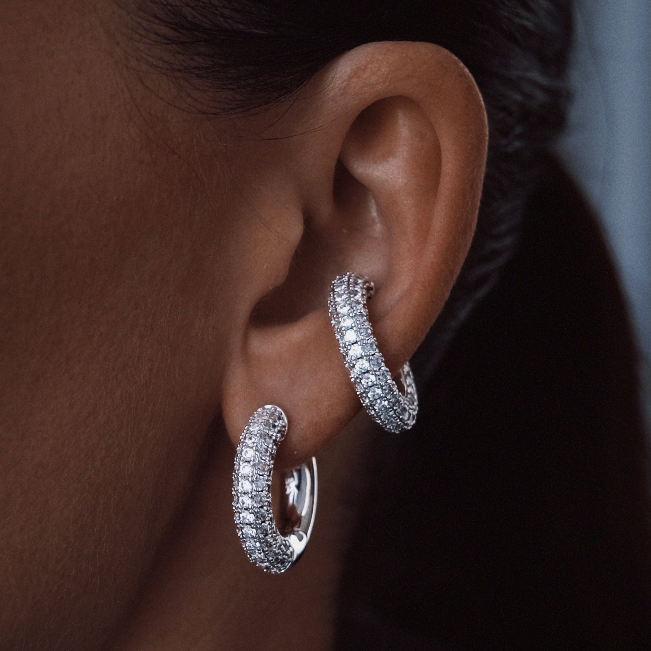 Chunky pavé zirconia hoop earring in silver color rhodium plated presented on an ear – Billion Avenue jewelry