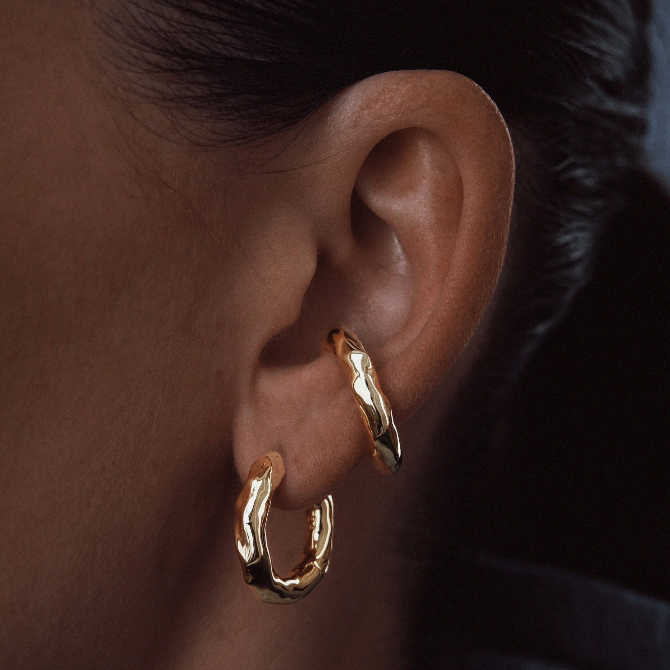 Molten ear cuff in 14k gold plated with organic design presented on an ear – Billion Avenue jewelry