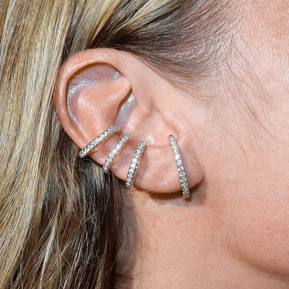 Triple zirconia ear cuff in silver color rhodium plated presented on an ear – Billion Avenue jewelry